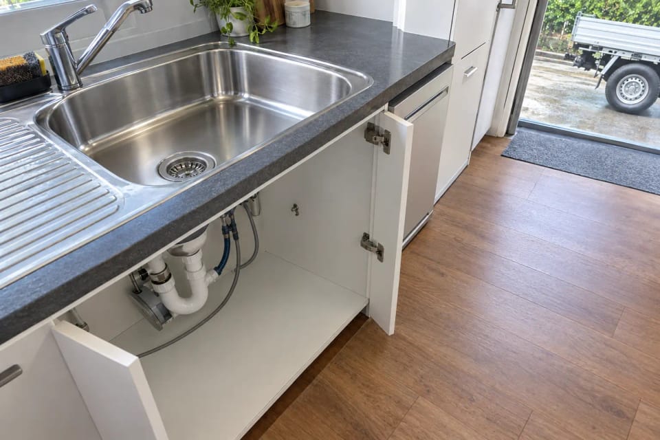 After: the same kitchen sink after the drain was cleared: empty, clean and shining.