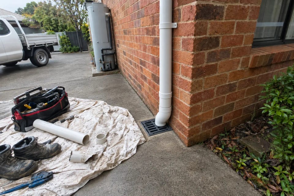 After: the same corner after a new downpipe was fitted and connected to stormwater, ground dry.